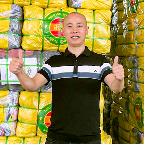 man standing in front of compressed bales