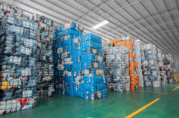 bales of unsorted used clothes factory