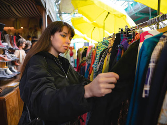 A lady checking out second hand coats