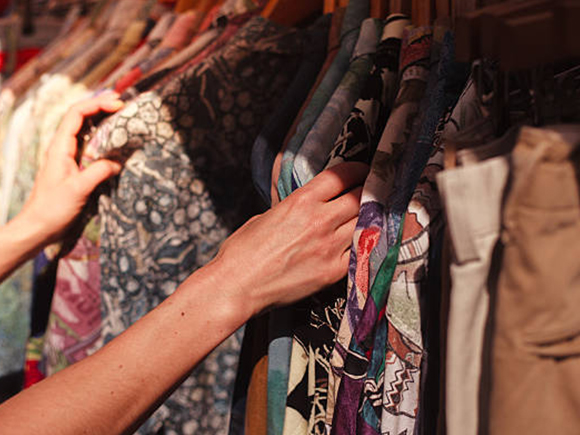 A Lady Checking Out Second hand Clothes