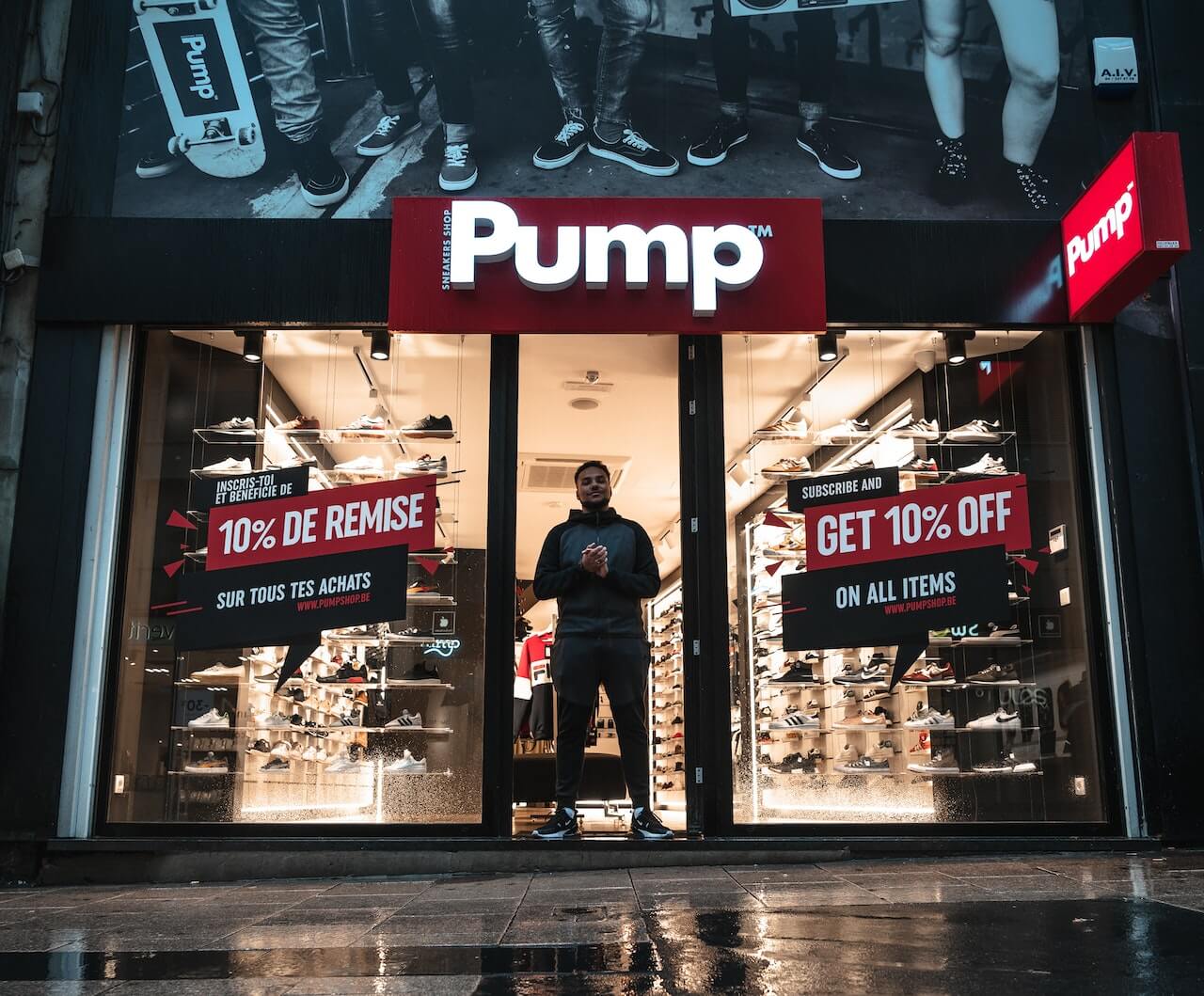 A Man standing outside a shoe store