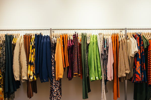 Multicolored clothes hanging on rack
