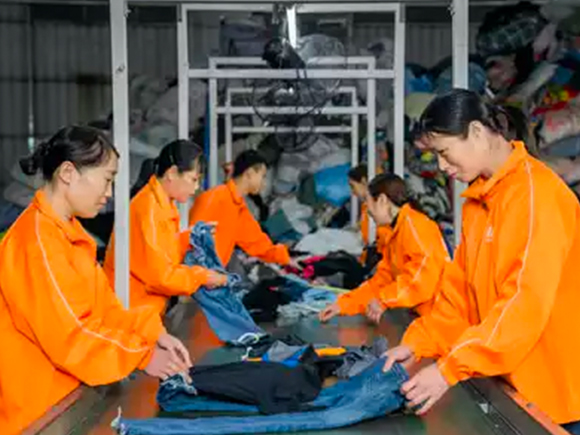 Professional workers efficiently sorting used clotes of Inditex clothes