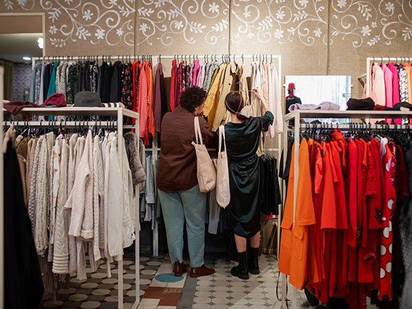 Two shoppers are shopping in second hand market clothes