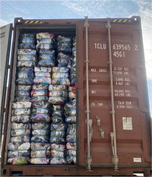 20 ft cargo container filled with bales of used shoes