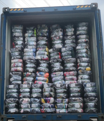 40 ft cargo container filled with bales of used shoes