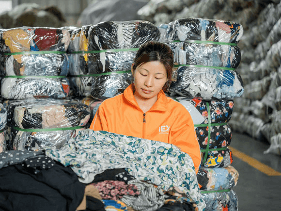 An inspector checks used clothes for quality inspection