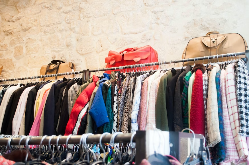 Used clothing hung on a rack in a shop