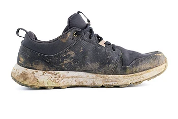 pair of used shoes with visible stains