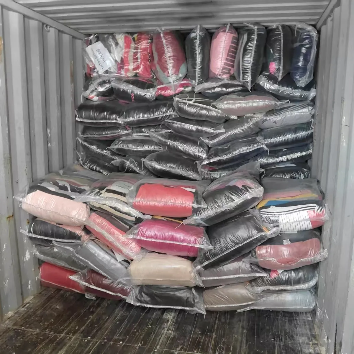bales of wholesale used clothes in a container