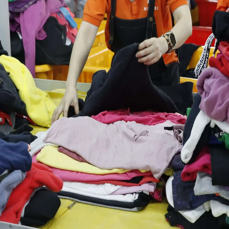 Workers are inspecting the quality of the second hand clothing Workers are inspecting the quality of the second hand clothing